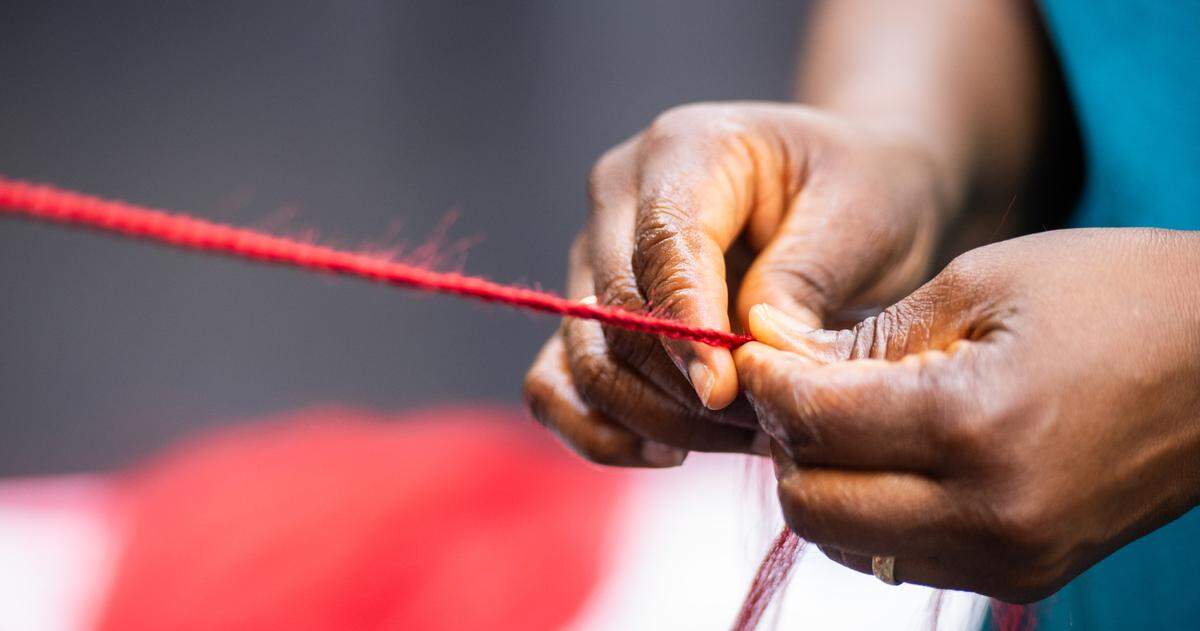 A woman getting colored knotless box braids at Top African Hair Braiding in Charlotte on August 7, 2024.