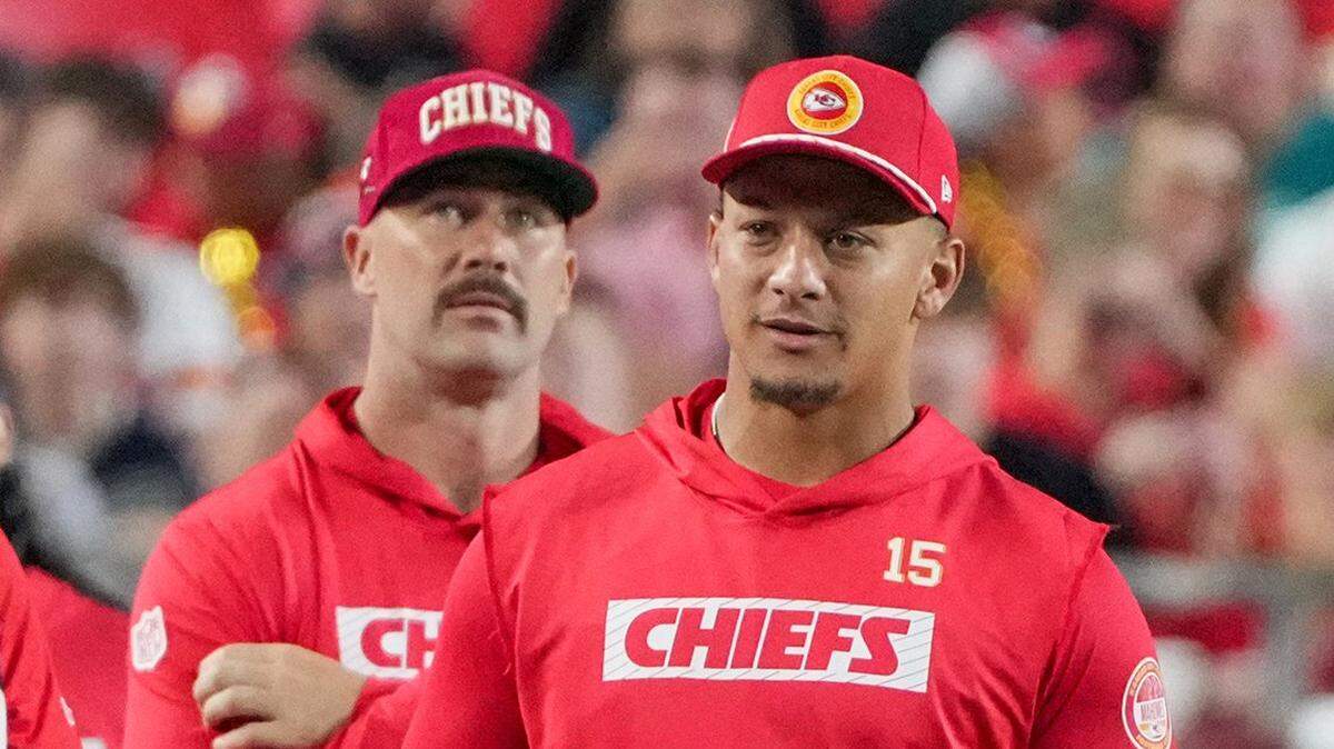 Aug 22, 2024; Kansas City, Missouri, USA; Kansas City Chiefs tight end Travis Kelce (87) and quarterback Patrick Mahomes (15) react to play on the sidelines against the Chicago Bears during the game at GEHA Field at Arrowhead Stadium.