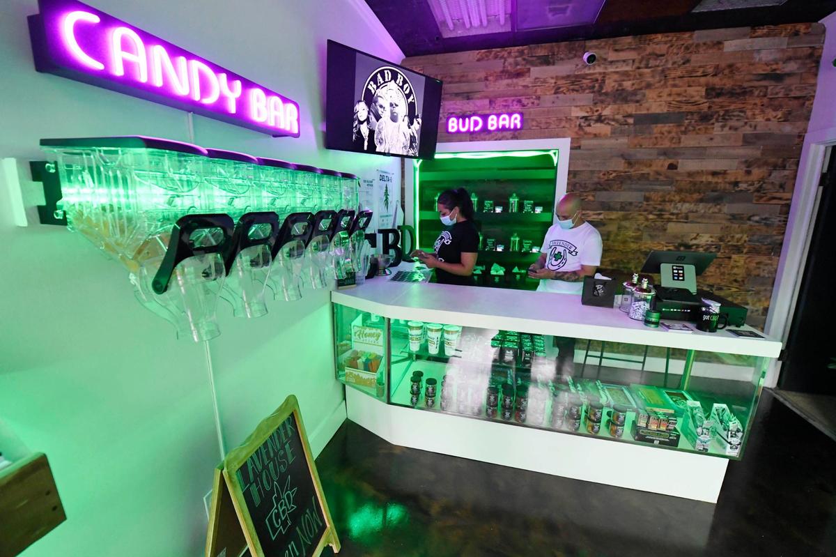 Lavender House owners Lindsey Smith, and Freddy Rosa work at their CBD dispensary Monday at 1101 E. 36th St in Charlotte.