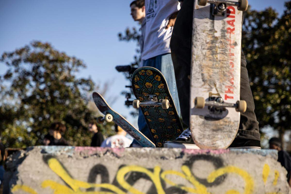 Skaters watch each other at Eastland DIY SkatePark on Friday, Feb. 18, 2022.