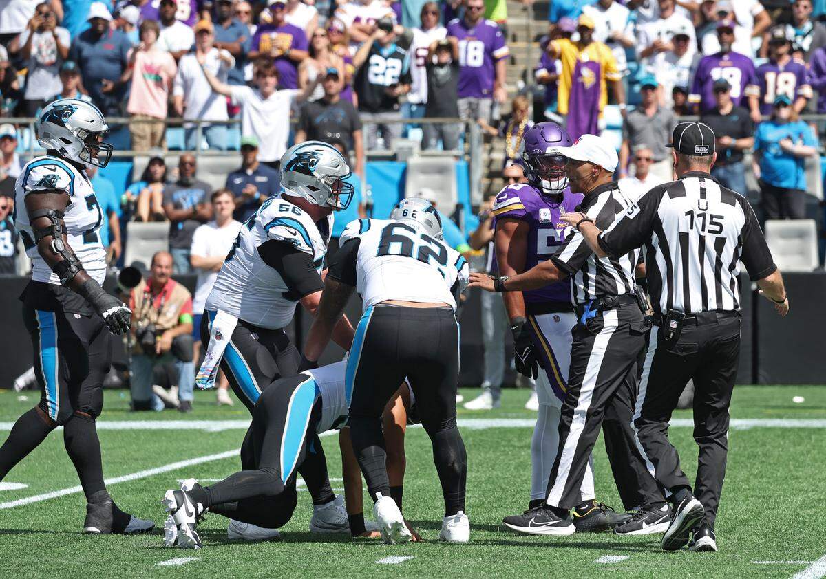 Members of the Carolina Panthers offensive line help quarterback Bryce Young to his feet after Young was hit by Minnesota Vikings linebacker Jordan Hicks on a play that had been blown dead during first-quarter action at Bank of America Stadium on Sunday, October 1, 2023. The Minnesota Vikings defeated the Panthers 21-13.