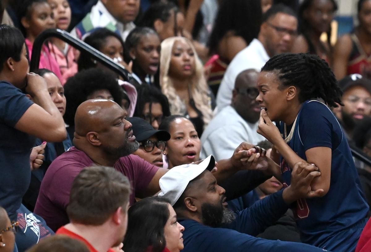 Mallard Creek’s Olivia Robertson, right, goes to the stands at North Meck High after being injured during action on Friday, February 2, 2024. Robertson’s father Eddie Robertson passed away two weeks ago and she has kept playing and dedicated her season to him.