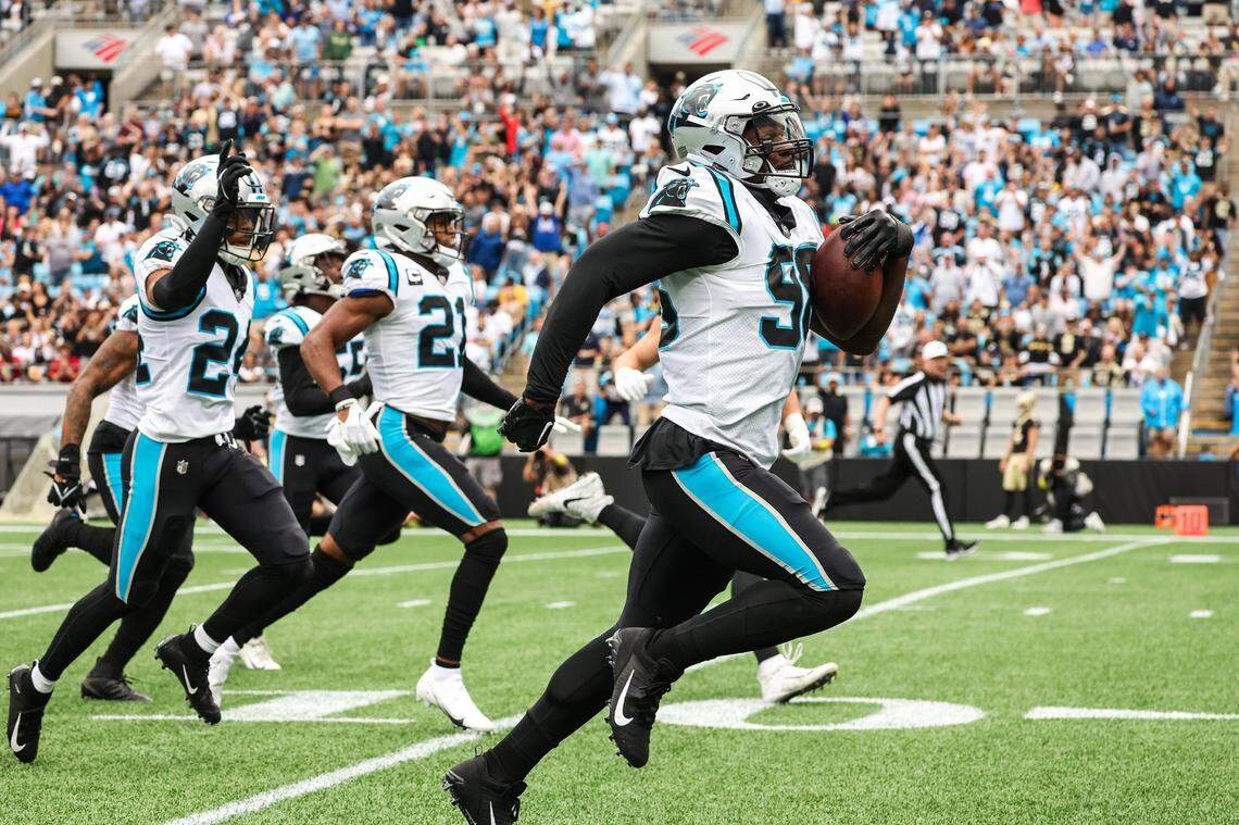 Panthers defensive end Marquis Haynes, right, runs toward the end zone with a recovered fumble during the game against the Saints at Bank of America Stadium on Sunday, September 25, 2022 in Charlotte, NC.