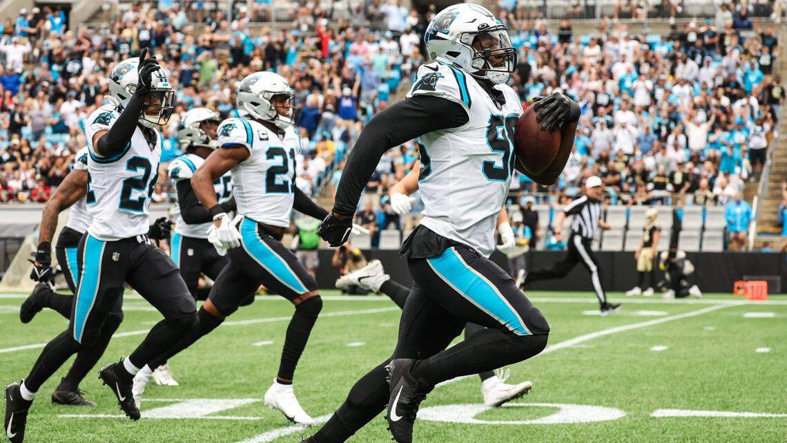 Panthers defensive end Marquis Haynes, right, runs toward the end zone with a recovered fumble during the game against the Saints at Bank of America Stadium on Sunday, September 25, 2022 in Charlotte, NC.