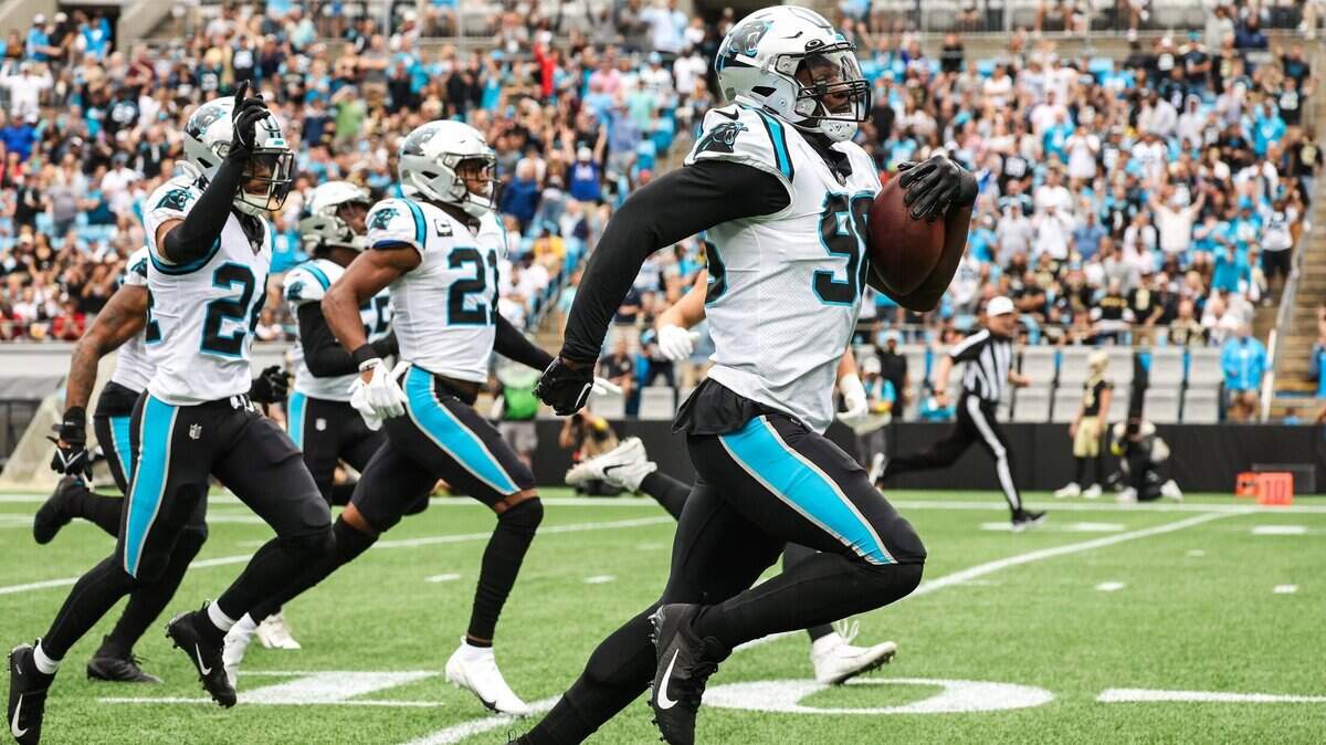Panthers defensive end Marquis Haynes, right, runs toward the end zone with a recovered fumble during the game against the Saints at Bank of America Stadium on Sunday, September 25, 2022 in Charlotte, NC.
