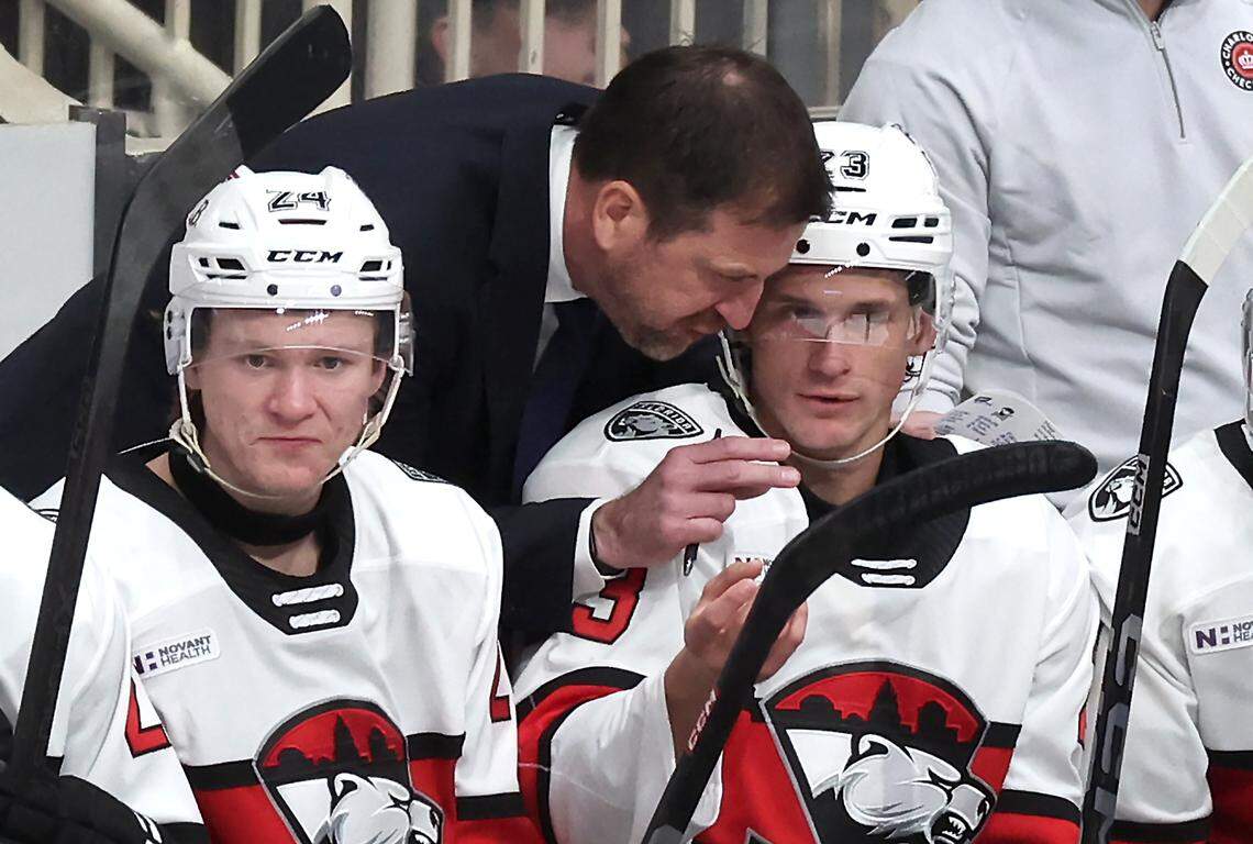 Charlotte Checkers head coach Geordie Kinnear, center, speaks with forward Jack Studnicka, right, following a series against the Iowa Wild on Friday, October 17, 2025 at Bojangles Coliseum in Charlotte, NC. 