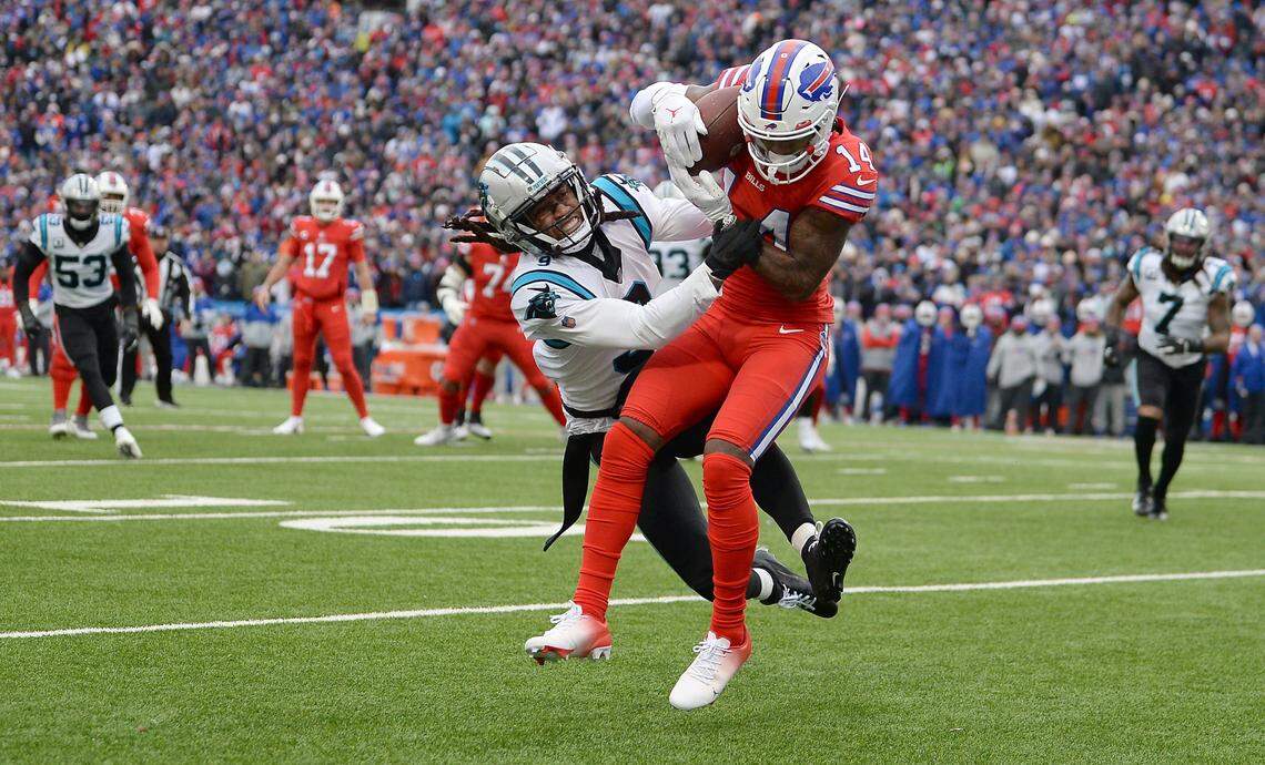 Carolina Panthers cornerback Stephon Gilmore, left, is unable to stop Buffalo Bills wide receiver Stefan Diggs, right, from catching a touchdown pass during second quarter action at Highmark Stadium in Orchard Park, NY on Sunday, December 19, 2021. 