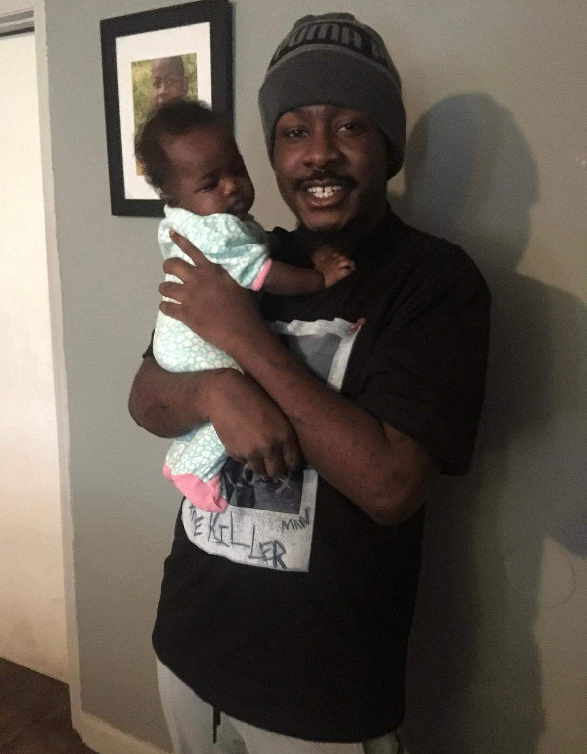 Jason Lipscomb and his one-year-old daughter, Jamira. Lipscomb was fatally shot by Gastonia police officers in July 2022.