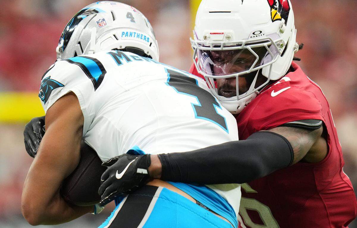 Arizona Cardinals cornerback Max Melton (16) tackles Carolina Panthers receiver Tetairoa McMillan (4) at State Farm Stadium on Sept 14, 2025.
