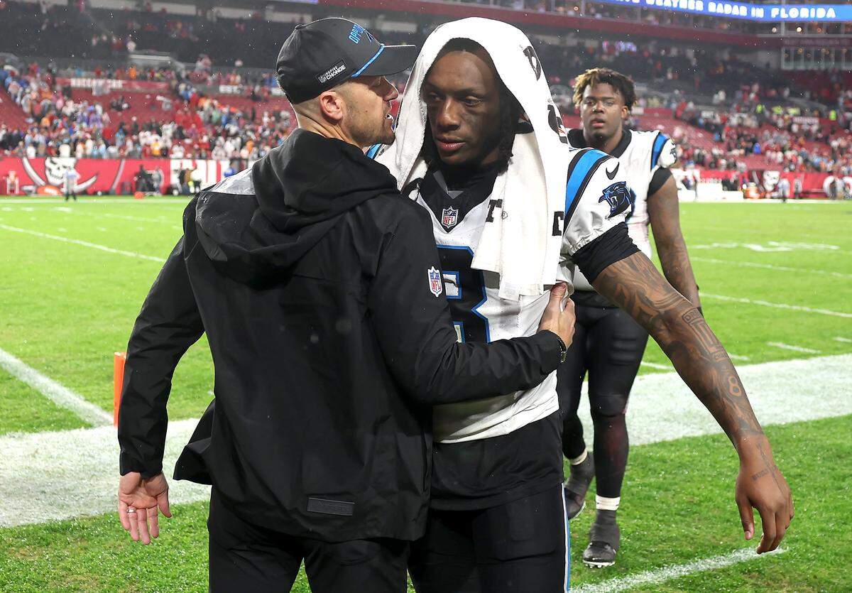 Carolina Panthers head coach Dave Canales, left, hugs cornerback Jaycee Horn, right, following the team’s 16-14 loss to the Tampa Bay Buccaneers at Raymond James Stadium in Tampa, FL.on Saturday, January 3, 2026. 