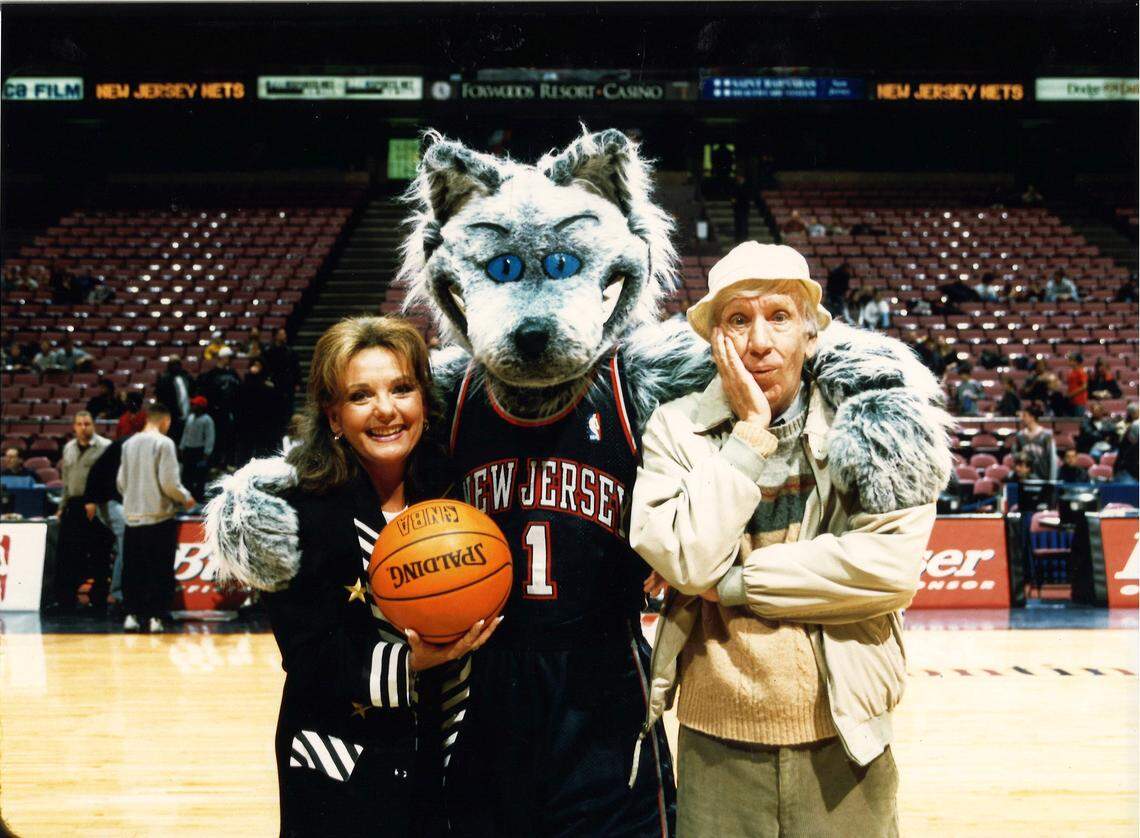 Miguel Vargas (center, in mascot costume) puts an arm around two actors from the old television show “Gilligan’s Island” prior to a New Jersey Nets game in the early 2000s. Dawn Wells (Mary Ann) is on the left; Bob Denver (Gilligan) is on the right.