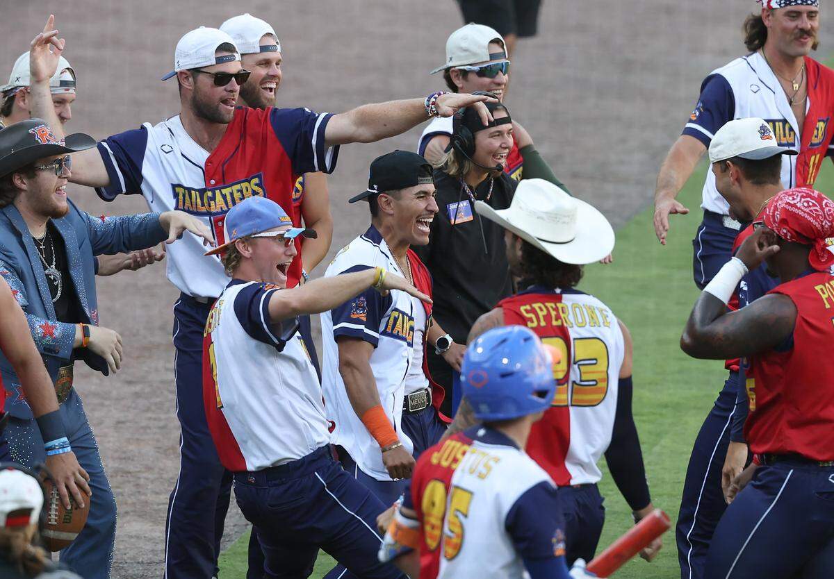 Members of the Texas Tailgaters celebrate a run during action against the Firefighters at Truist Field in Charlotte, NC on Thursday, June 4, 2026. Banana Ball action returned to the Queen City with the Texas Tailgaters battling the Firefighters.