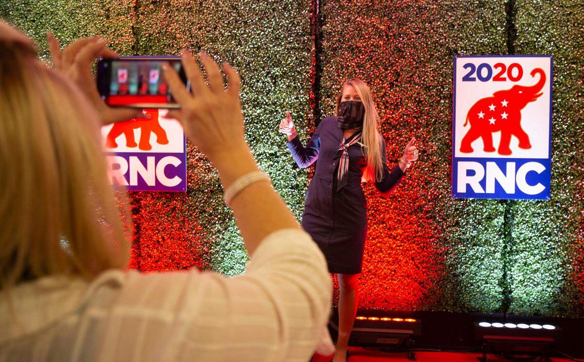 Ellen Smith, an American Airlines employee gets her photo taken by Michele Fiore, a City Councilwoman for Las Vegas at the RNC welcome station at the Charlotte Douglas International Airport in Charlotte, NC on Thursday, August 20, 2020.
