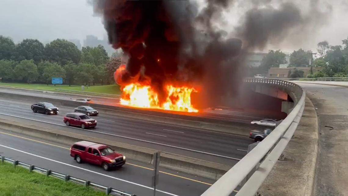 In this image from Charlotte Fire Department video, flames engulf a vehicle on Interstate 77 near Freedom Drive just outside of uptown Charlotte, NC, on Tuesday, Aug. 16, 2022.