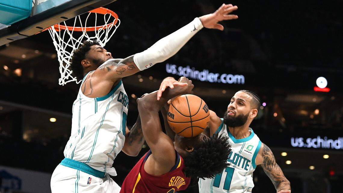 Charlotte Hornets forward Miles Bridges, left and forward Cody Martin, right, apply defensive pressure on Cleveland Cavaliers guard Collin Sexton during second half action at Spectrum Center in Charlotte, NC on Monday, November 1, 2021.