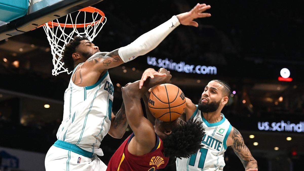 Charlotte Hornets forward Miles Bridges, left and forward Cody Martin, right, apply defensive pressure on Cleveland Cavaliers guard Collin Sexton during second half action at Spectrum Center in Charlotte, NC on Monday, November 1, 2021.