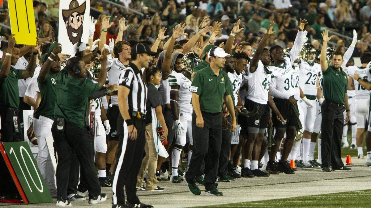 Charlotte 49ers coach Will Healy (white hat) has faced Appalachian state before as a player and coach.