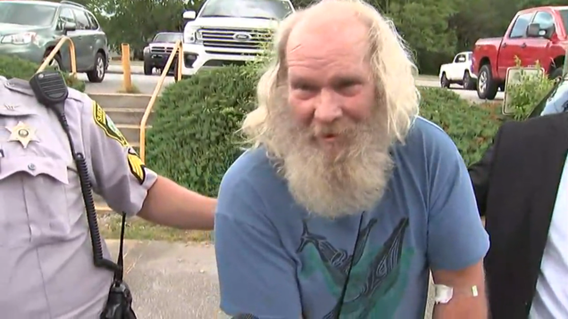 Edwin Hiatt being escorted to jail on Burke County, where he is charged with killing Barry Crane in 1985.