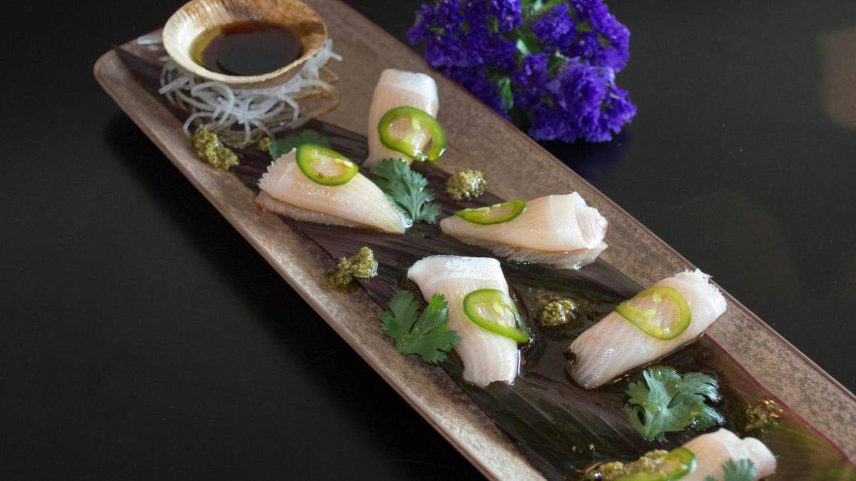 The extensive menu offers a variety of sushi and sashimi options, including this Hamachi Pesto.