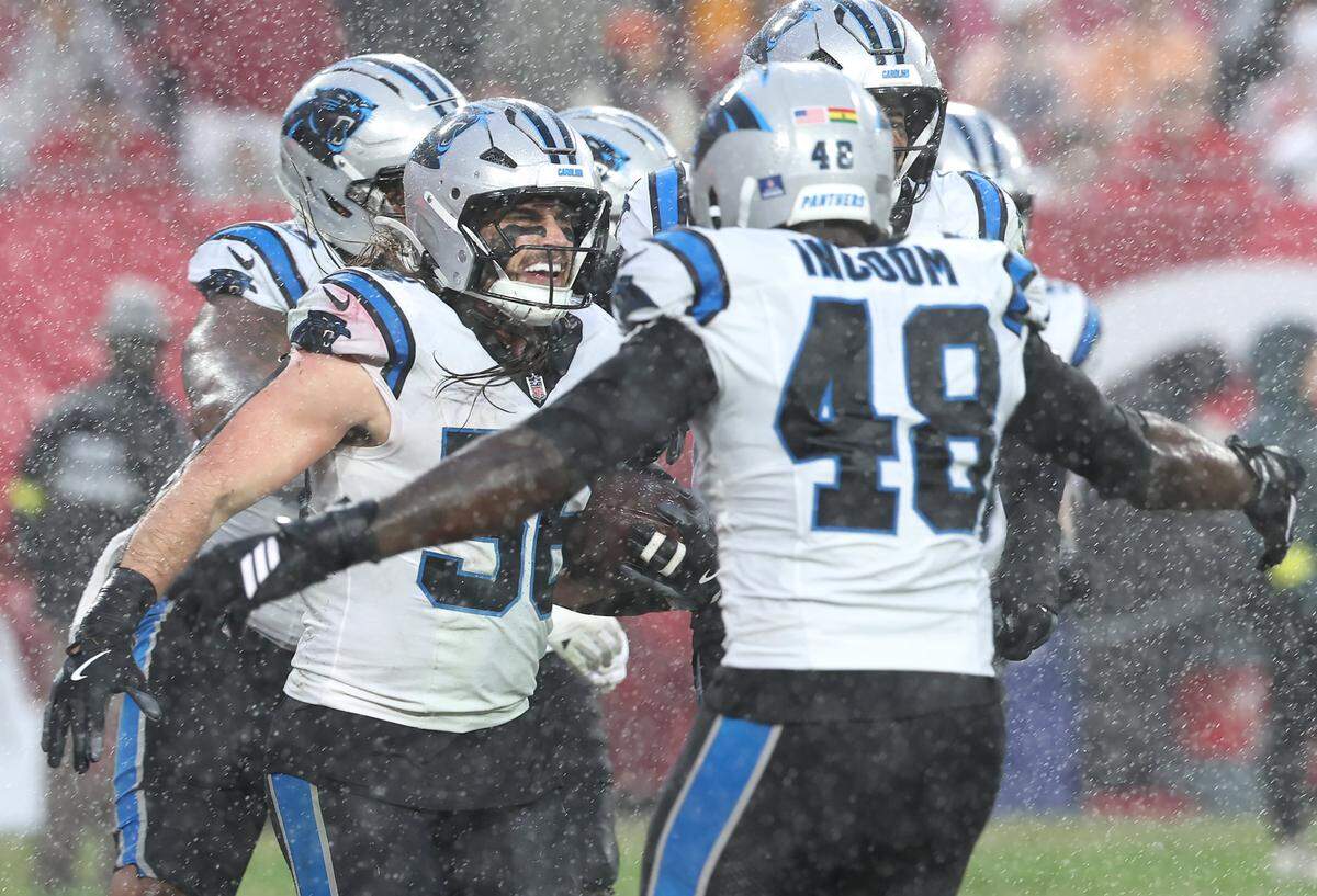 Carolina Panthers linebacker Christian Rozeboom, left, is congratulated by his teammates after intercepting a pass by Tampa Bay Buccaneers quarterback Baker Mayfield during action at Raymond James Stadium in Tampa, FL.on Saturday, January 3, 2026. 