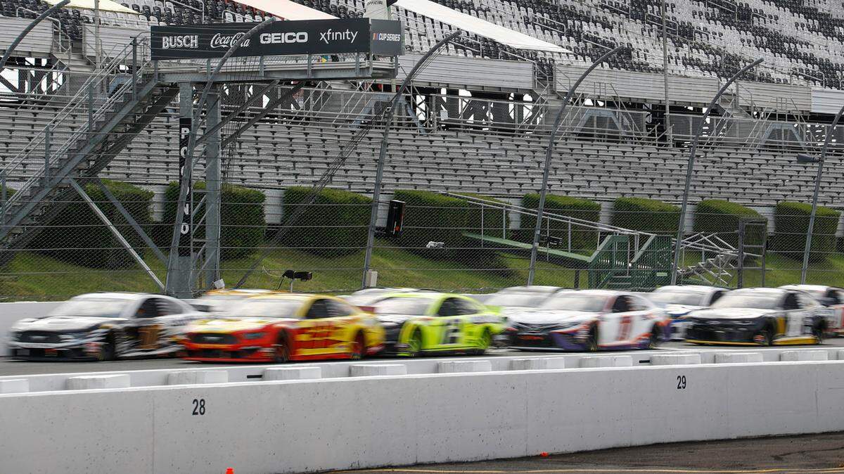 Aric Almirola (10) and Joey Logano (22) are a blur as they lead the pack under the green flag for a restart after a yellow flag during the NASCAR Cup Series auto race at Pocono Raceway, Saturday, June 27, 2020, in Long Pond, Pa. (AP Photo/Matt Slocum)