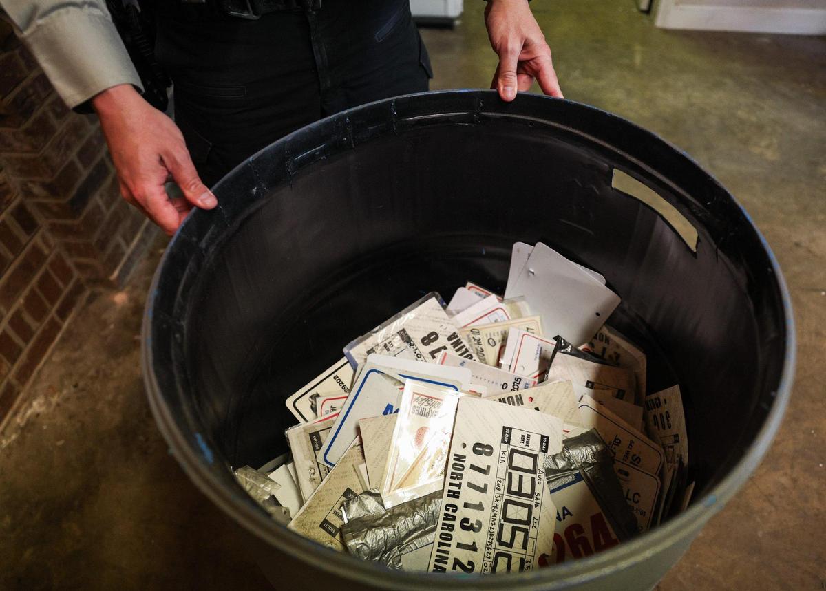 More than 1,000 fake license plates sit in a trash can at the Union County sheriff’s office.