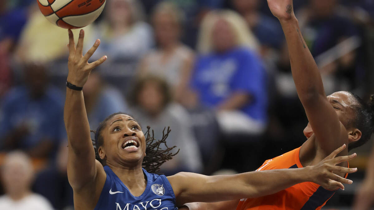 Tanisha Wright (left) is a guard for the Minnesota Lynx in the summer. In the winter, she’s an assistant women’s basketball coach for the Charlotte 49ers.