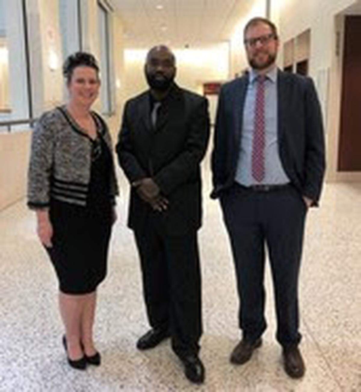 Lindsey Guice Smith, left, executive director of the N.C. Innocence Inquiry Commission, poses with Israel Grant and commission staff attorney Brian Ziegler.