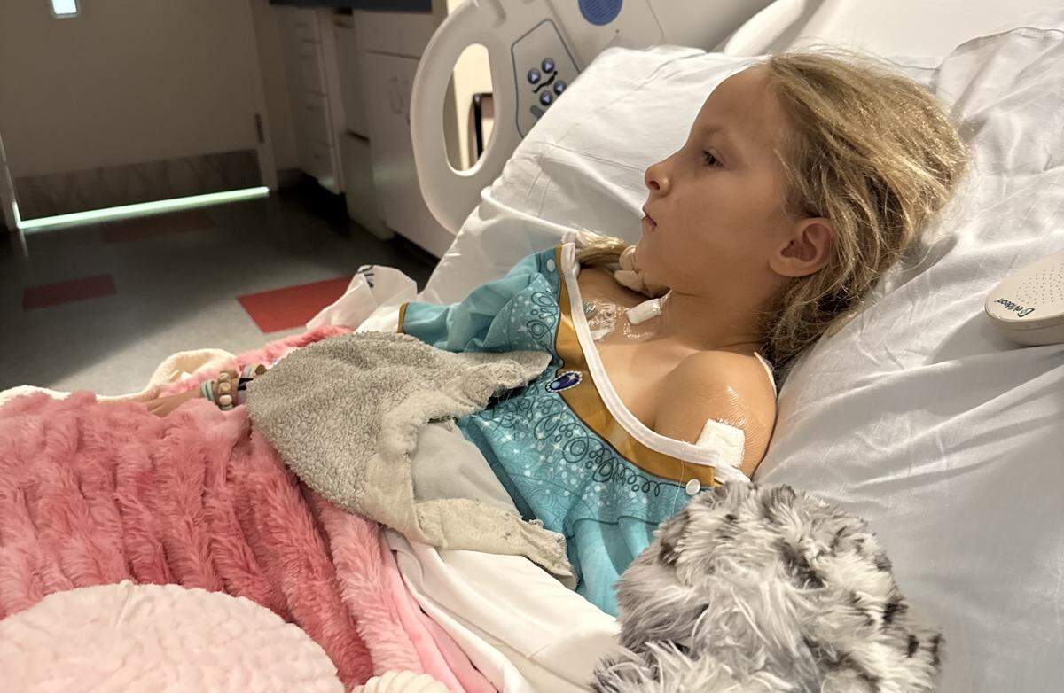 Annie Smith rests in a hospital bed at St. Jude Children’s Research Hospital in Memphis as she undergoes treatment.
