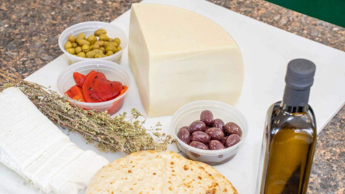 Feta and Kefalograviera cheeses kalamata olives, roasted red peppers, pita bread and oregano at Agora Greek Market.