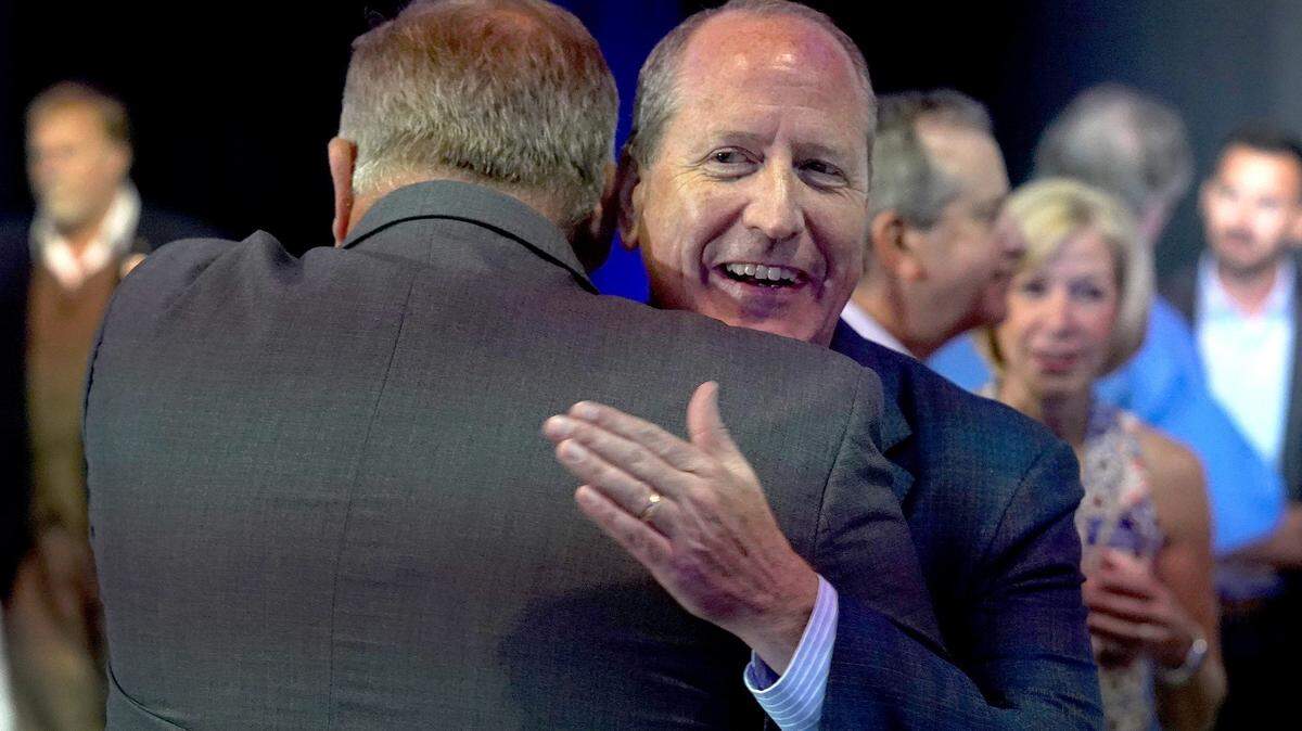 Dan Bishop, facing camera, Republican candidate for the ninth district in North Carolina hugs a supporter in Monroe, NC on Tuesday, September 10, 2019 shortly after the polls closed.