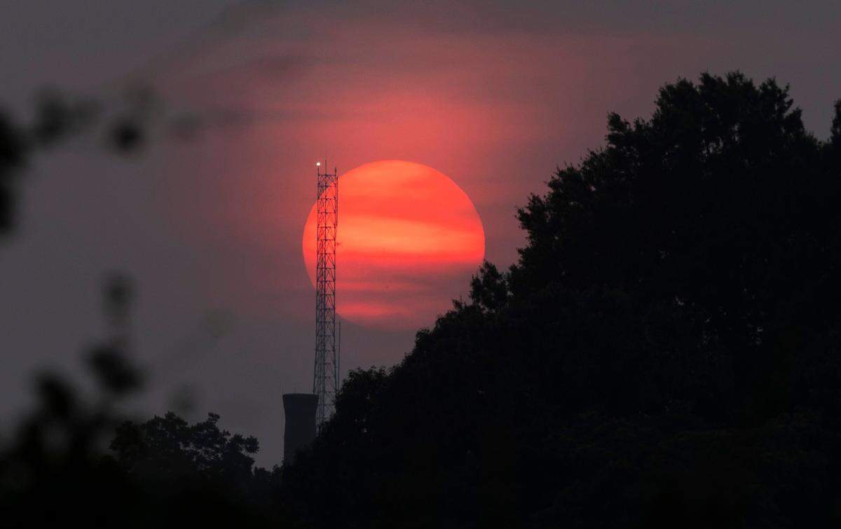 The sun sets looking west from the Boylan Avenue bridge in Raleigh, N.C. Tuesday, June 6, 2023. More than 400 Canadian wildfires continue to scorch land near Quebec, sending clouds of smoke downwind to the United States, including the Carolinas. 