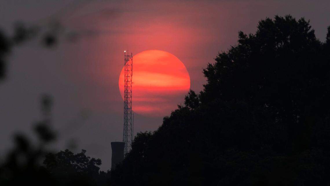 The sun sets looking west from the Boylan Avenue bridge in Raleigh, N.C. Tuesday, June 6, 2023. More than 400 Canadian wildfires continue to scorch land near Quebec, sending clouds of smoke downwind to the United States, including the Carolinas.
