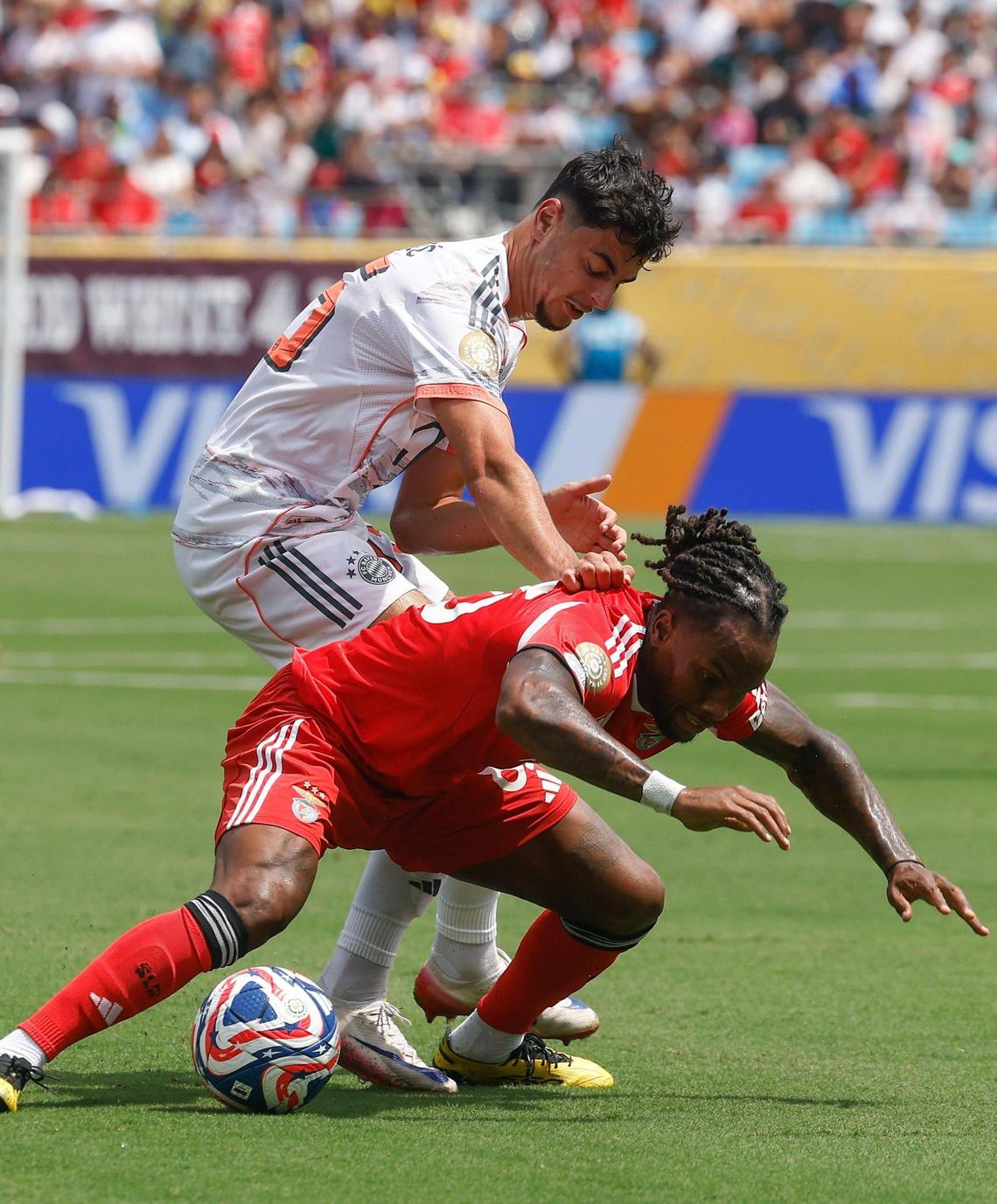 S.L. Benfica’s midfielder Renato Sanches, front, is pushed down by Bayern München’s midfielder Aleksandar Pavlovic during the FIFA Club World Cup at Bank of America Stadium in Charlotte, NC on Tuesday, June 24, 2025.