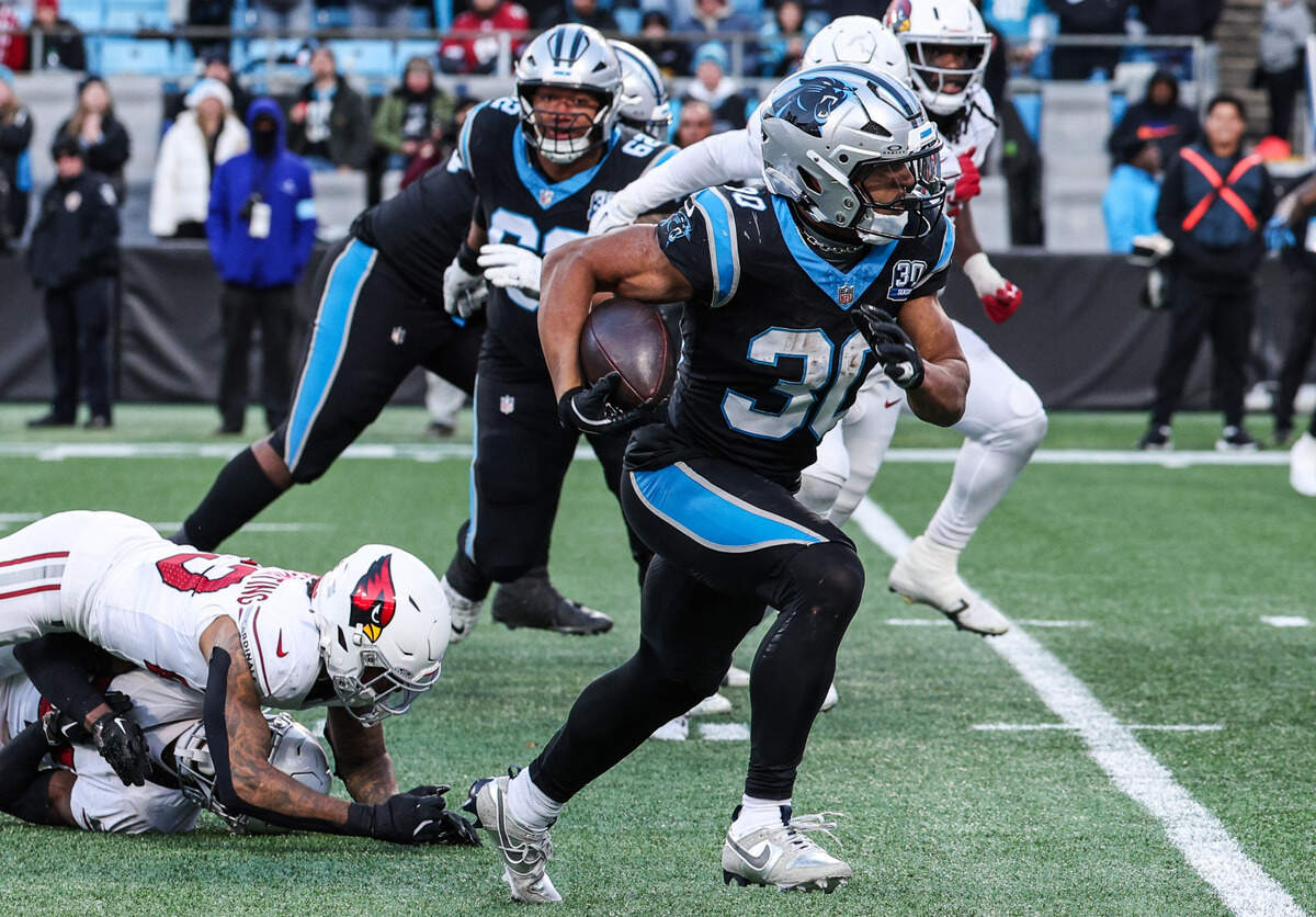 Panthers unning back Chuba Hubbard breaks away from the Cardinals defenders at Bank of America Stadium in Charlotte, NC on Sunday, December 22, 2024.