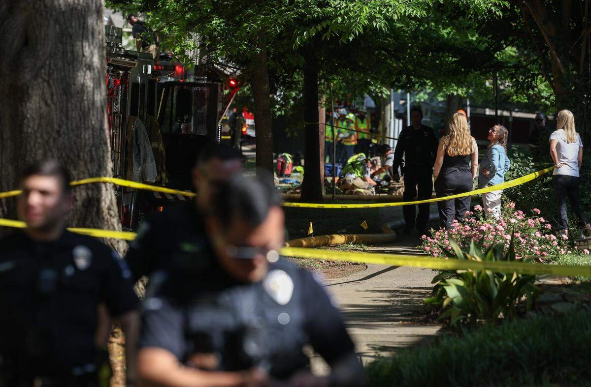 Neighbors watch fire fighters work the scene where an explosion was reported at a hone on Lombardy Circle early Friday morning, May 2, 2025.