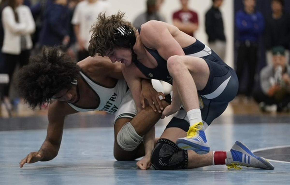 Charlotte Country Day's Dante Graham, left, tries to break out of a leg hold by Cary Christian's Joshua Stonebraker during their 157-pound championship match Saturday at the N.C. Independent Schools Athletic Association's state championships in Charlotte. BY BILL KISER/SPECIAL TO THE OBSERVER