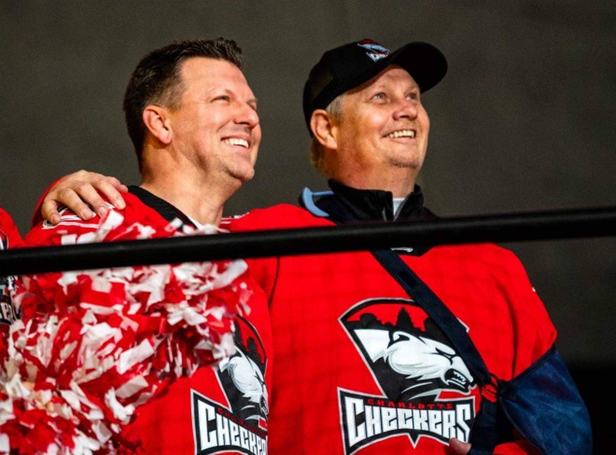 Dr. Craig Bryant, left, enjoys a Charlotte Checkers hockey game with Jib Street, whose life Bryant saved by administering CPR when Street collapsed at the Pineville Ice House.