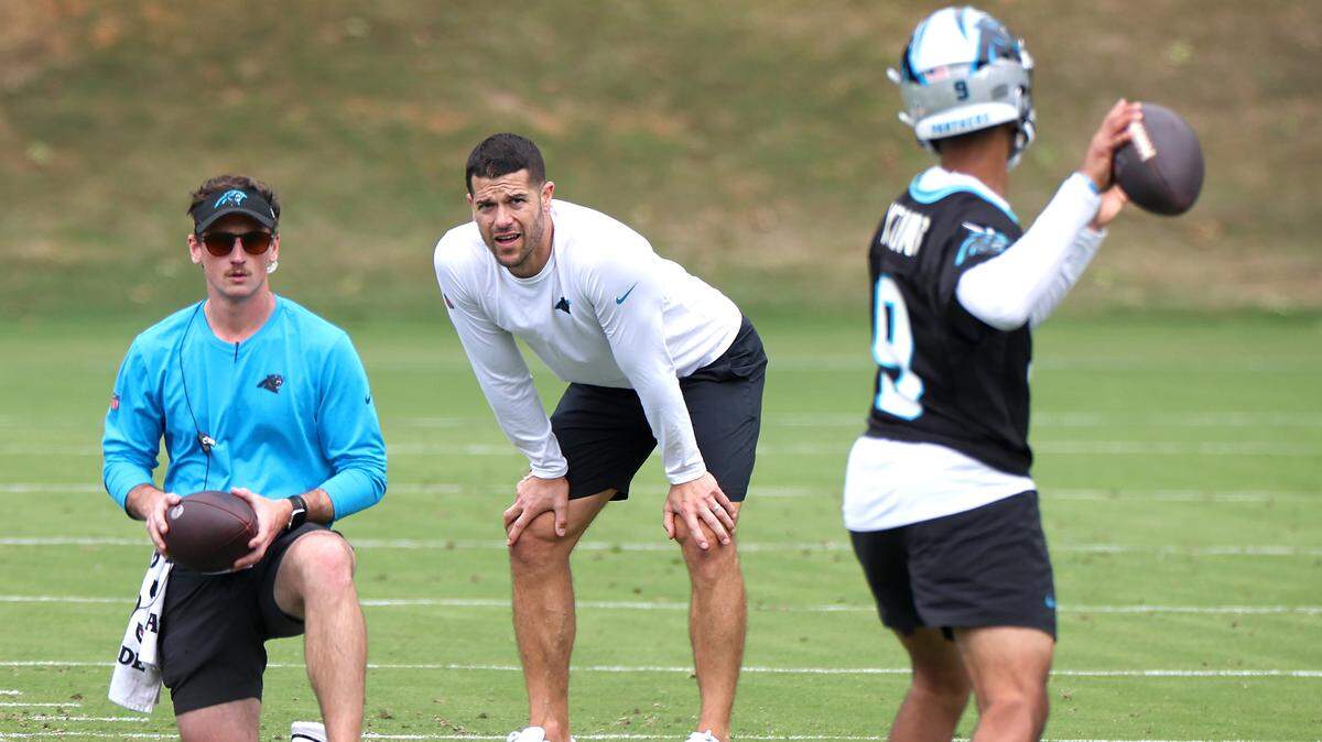 Carolina Panthers head coach Dave Canales, center, watches as quarterback Bryce Young, right, drops back to pass during the team’s voluntary minicamp on Wednesday, April 24, 2024.