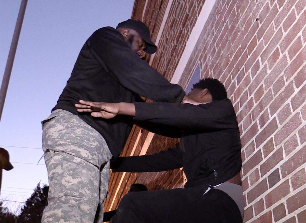 A Chester County Sheriff’s deputy makes a boy do exercises at the Project S.T.O.R.M. in January.