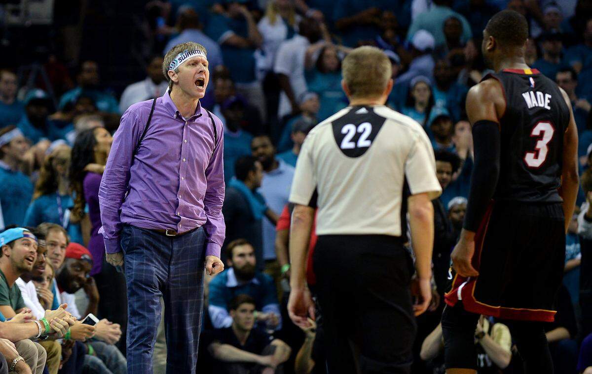 Miami Heat guard Dwyane Wade (right) stares back at Charlotte Hornets fan Michael Deason after scoring in Game 6 of the Hornets-Heat playoff series in 2016. Deason would forever be known as “purple shirt guy” in Hornets lore. He said at the time he didn’t plan to renew his season tickets.