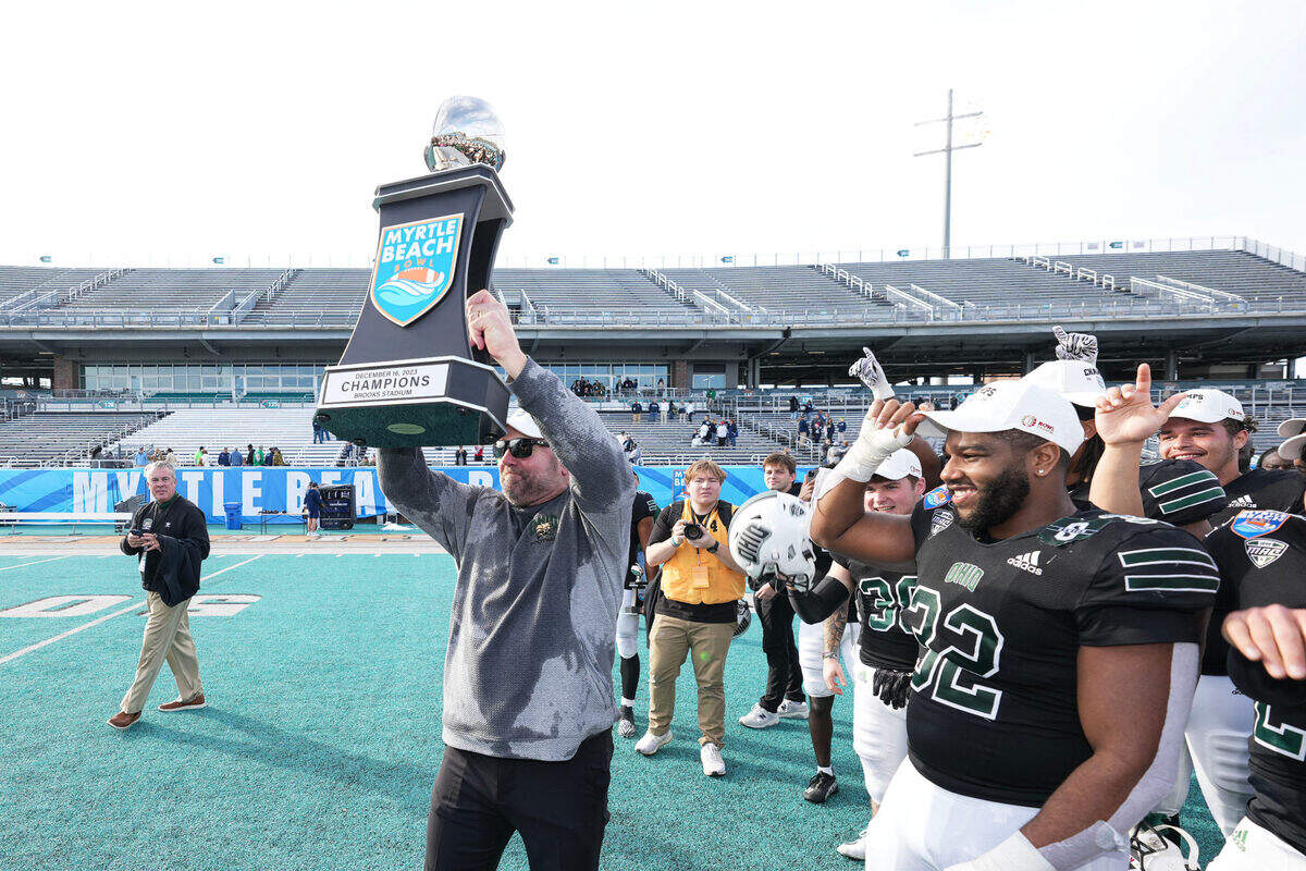 Dec 16, 2023; Conway, SC, USA; Ohio Bobcats head coach Tim Albin celebrates with the Champions trophy after defeating the Georgia Southern Eagles at Brooks Stadium.