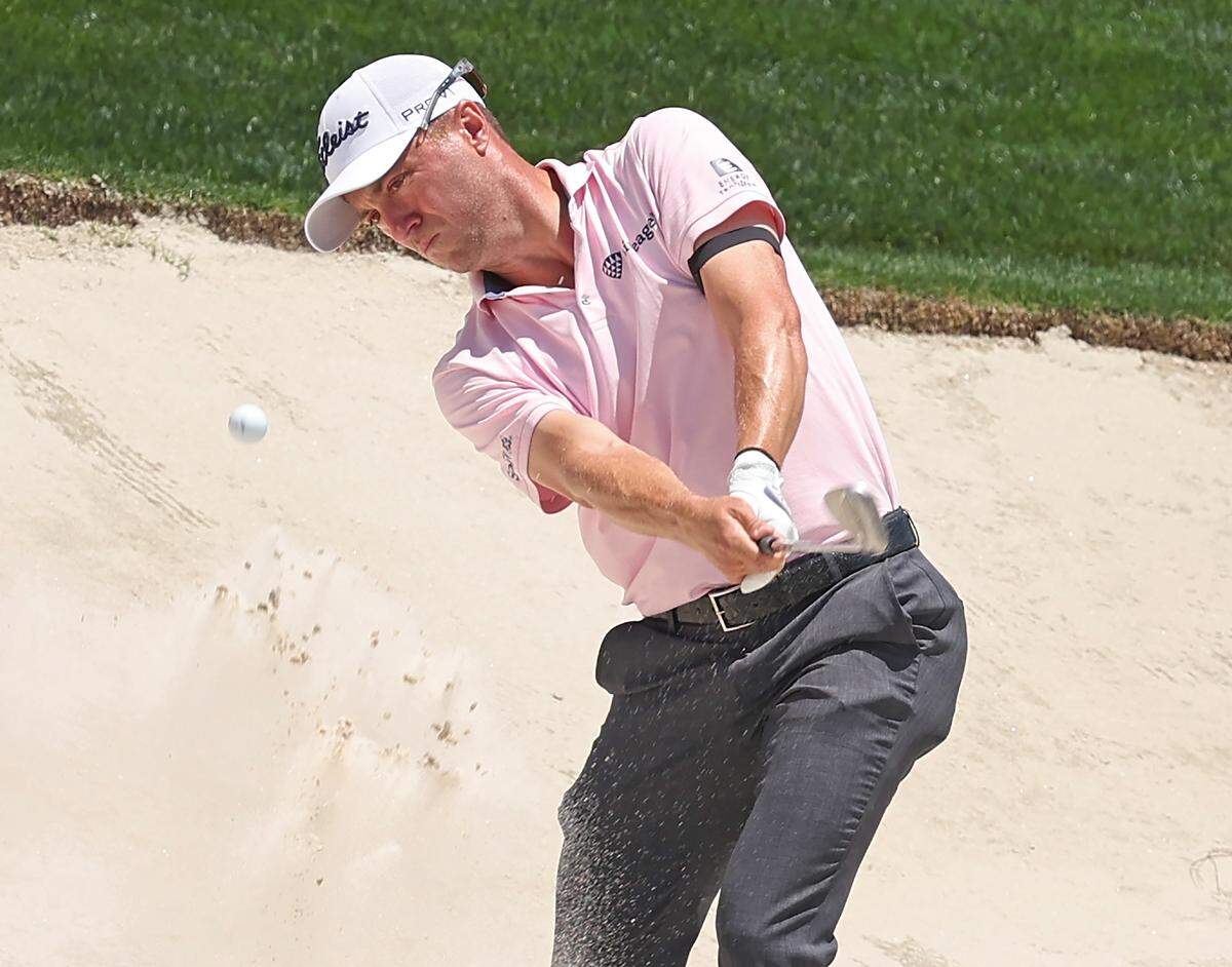 Justin Thomas hits his third shot from a sand trap along the 15th green during Round 2 of the Truist Championship at Quail Hollow Club on Friday, May 8, 2026.