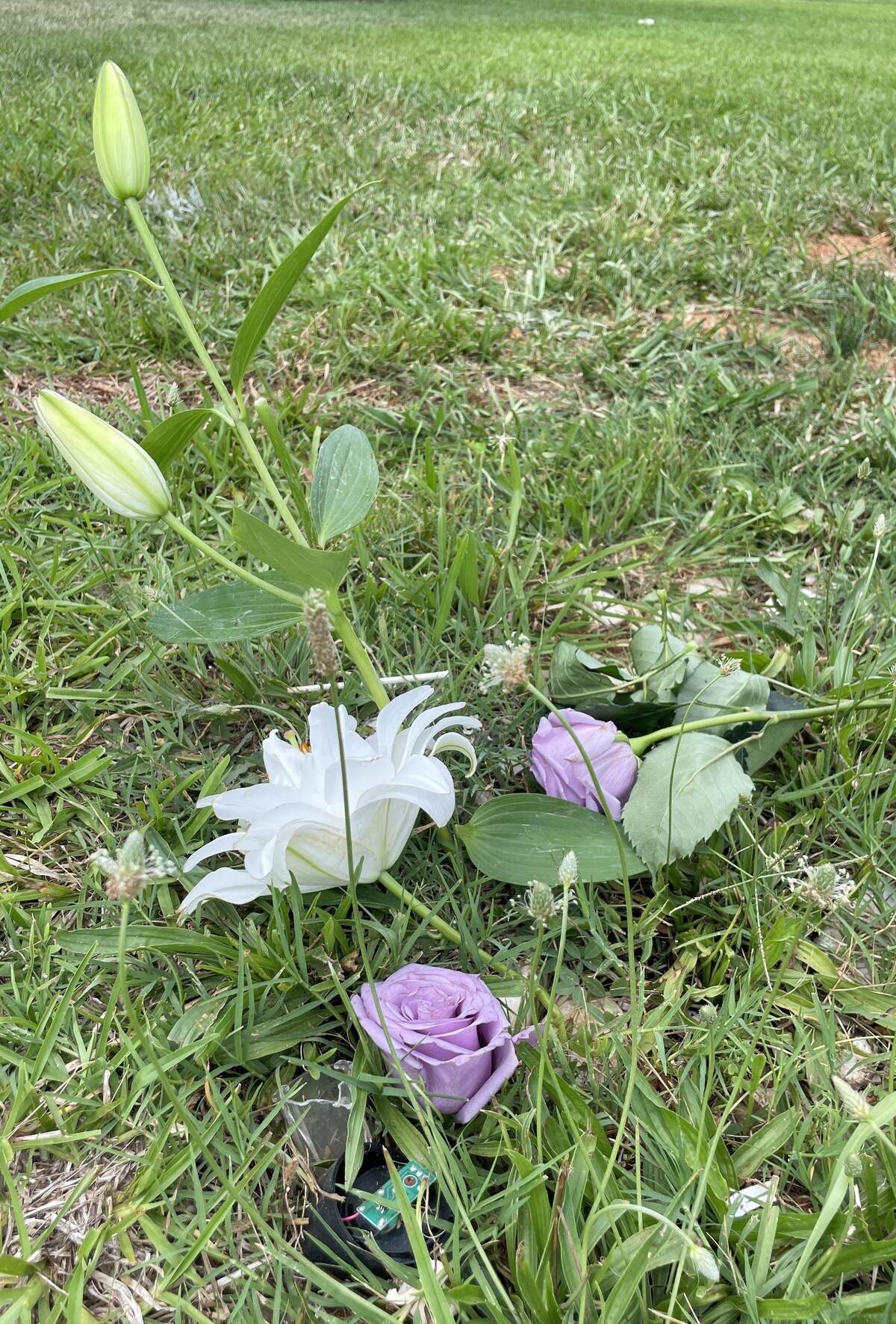 Flowers from his mother’s funeral rest on Sanrico McGill’s grave at Oaklawn Cemetery on Saturday, June 13, 2026.
