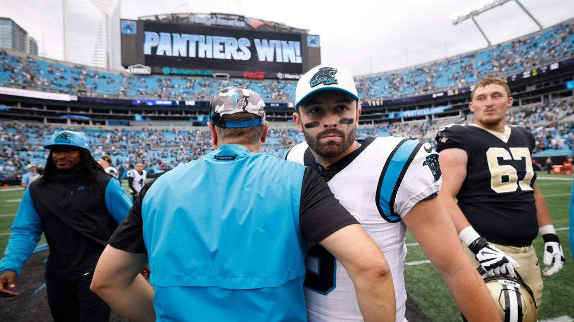 Carolina Panthers head coach Matt Rhule shakes hands with Carolina Panthers quarterback Baker Mayfield (6) after the Panthers defeated the New Orleans Saints 22-14 during a game at Bank of America Stadium in Charlotte, N.C., Sunday, Sept. 25, 2022.