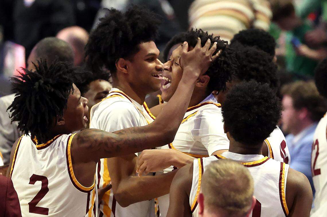 Members of the West Charlotte Lions surround Sean Johnson, center, after he hit the game-winning basket against Hoggard in the closing seconds of the NCHSAA 8A state championship game at Lawrence Joel Veterans Memorial Coliseum in Winston-Salem, North Carolina, on Wednesday, March 11, 2026. West Charlotte defeated Hoggard 70-68.