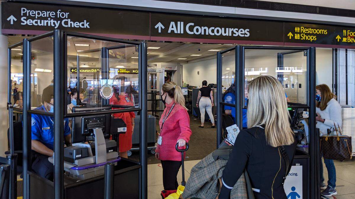 Passengers prepare to go through security Charlotte Douglas International Airport Wednesday November 18, 2020. American Airlines is preparing for a spike in traffic out of hub ahead of Thanksgiving.