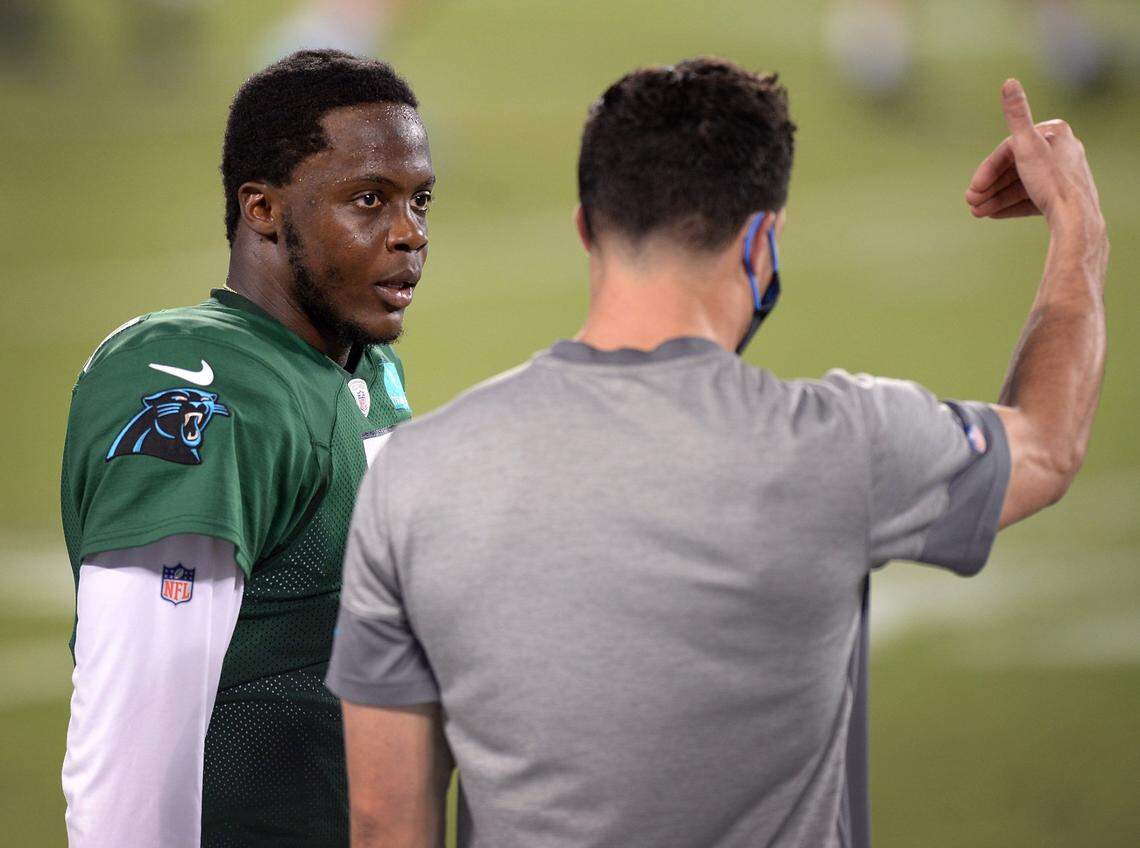 Carolina Panthers quarterback Teddy Bridgewater, left, listens to former Panthers linebacker Luke Kuechly, right, during practice at Bank of America Stadium on Aug. 26.