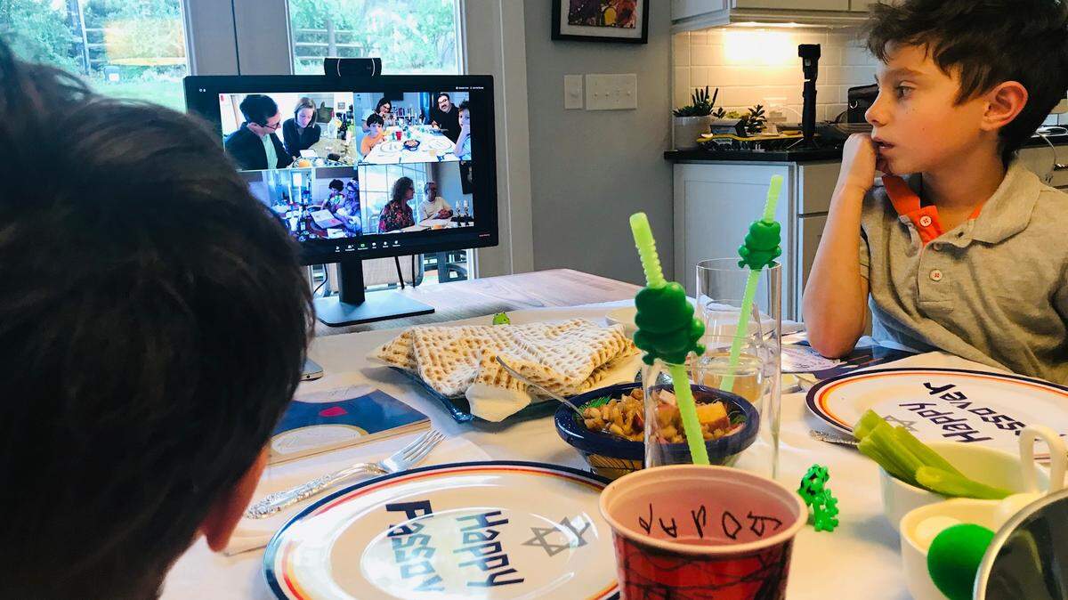 Micah Knight, 8, and brother Jonas Knight, 4, helped to prepare the table for their first virtual Passover Seder on Wednesday, April 8, 2020.