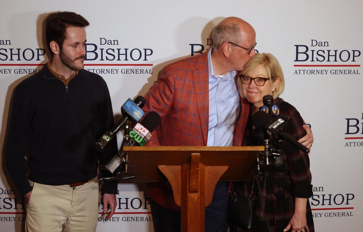 Congressman Dan Bishop, center, kisses his wife, Jo, right, as son Jack, left, looks on after conceding the race for the NC Attorney General to Jeff Jackson on Tuesday, November 5, 2024.